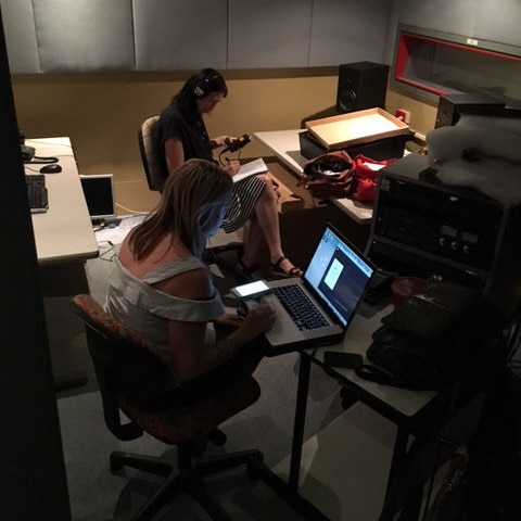 Rachael Brown working at laptop on Trace podcast production in ABC studios.