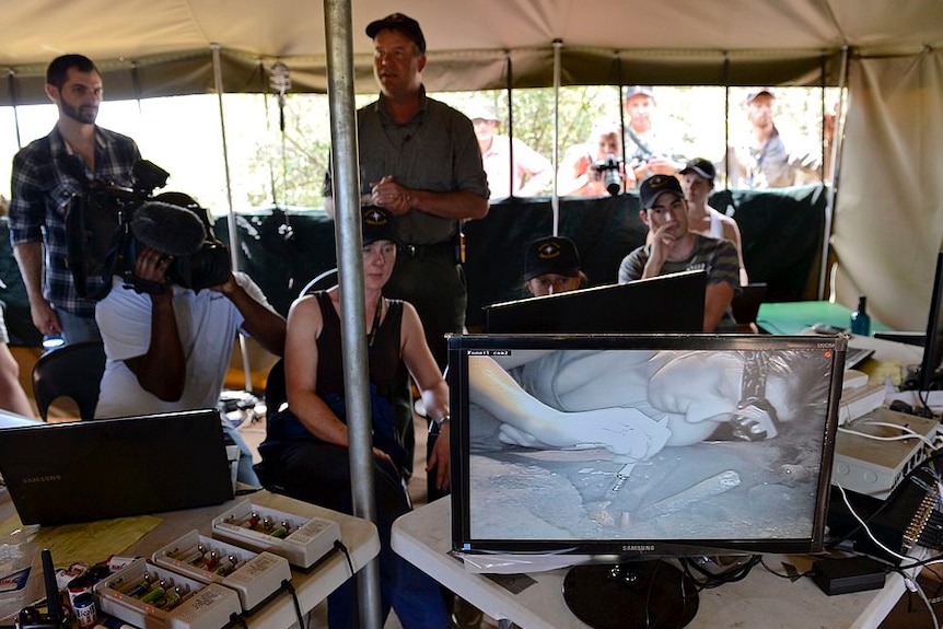 Scientists monitor their colleagues excavating a cave   Getty Images