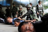 Red Shirt anti-government protestors are detained by soldiers inside their camp in Bangkok.
