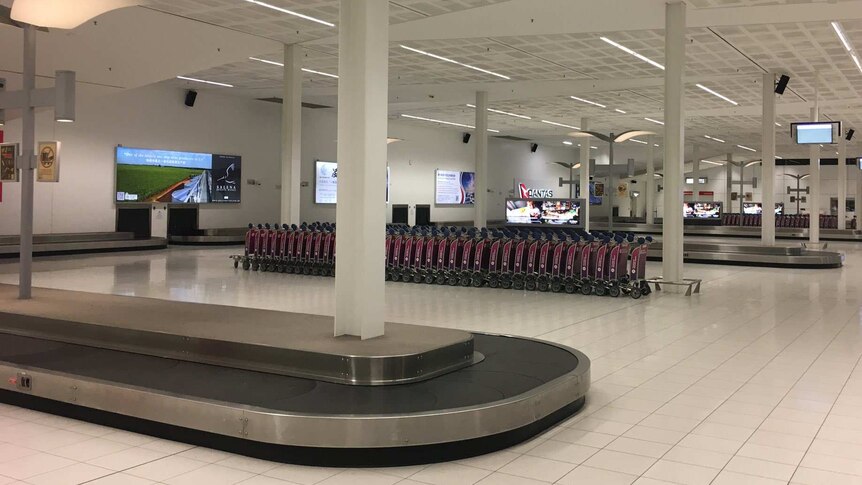 Empty area around baggage carousels at an airport
