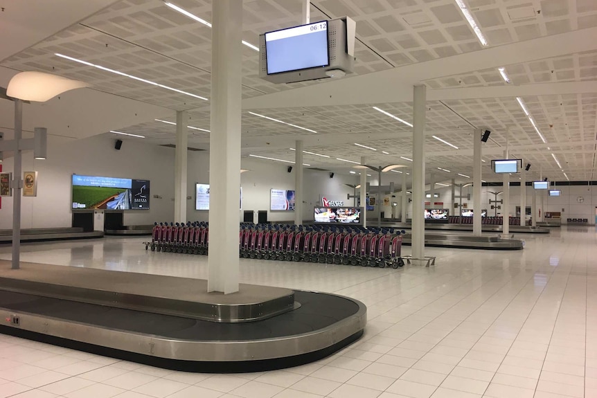 Empty area around baggage carousels at an airport