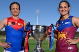Daisy Pearce and Breanna Koenen hold the AFLW premiership cup between them