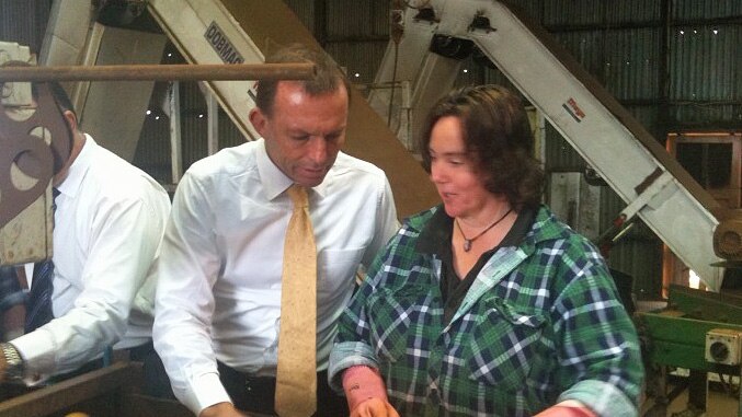 Tony Abbott talks to an onion factory worker in Tasmaia