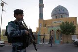 Iraqi policeman outside Sunni mosque in Baghdad