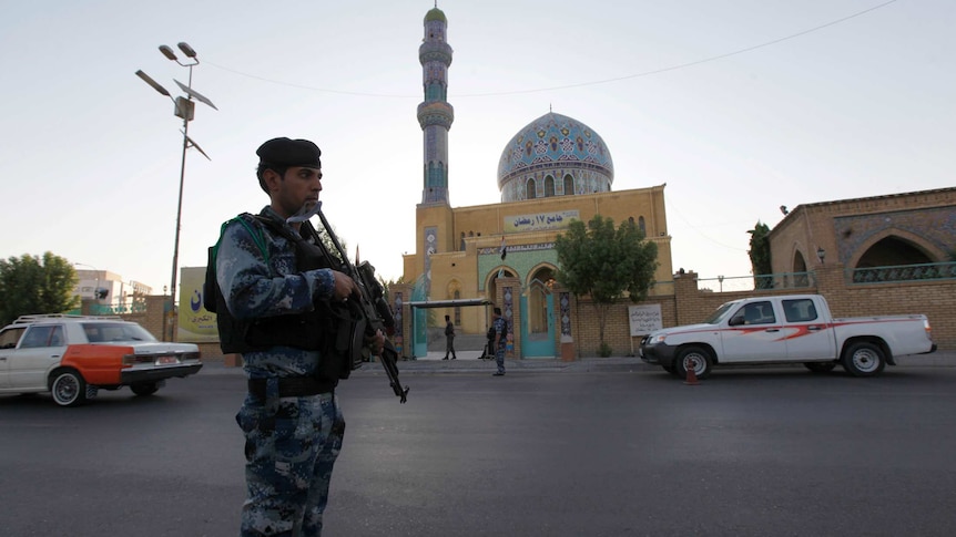 Iraqi policeman outside Sunni mosque in Baghdad