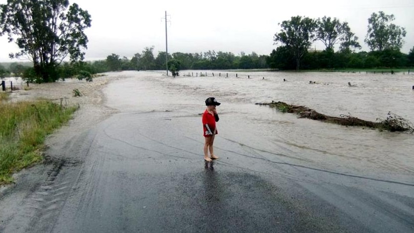 A boy watches the floodwaters at Bancroft.