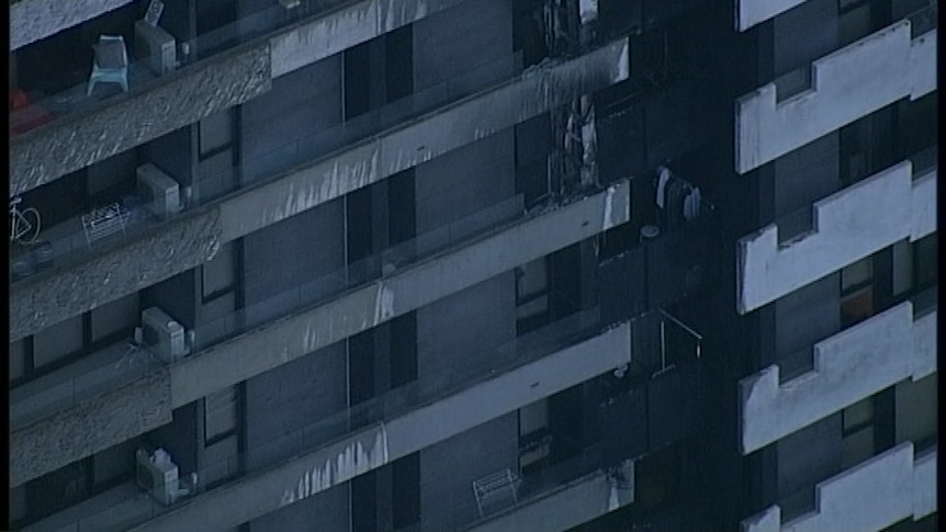 The charred exterior of several balconies of an apartment complex.