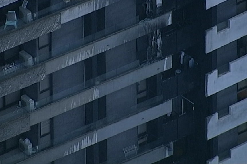 The charred exterior of several balconies of an apartment complex.