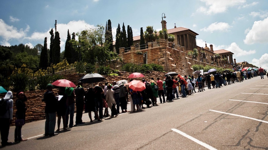People queue to bid farewell to former South African president Nelson Mandela.