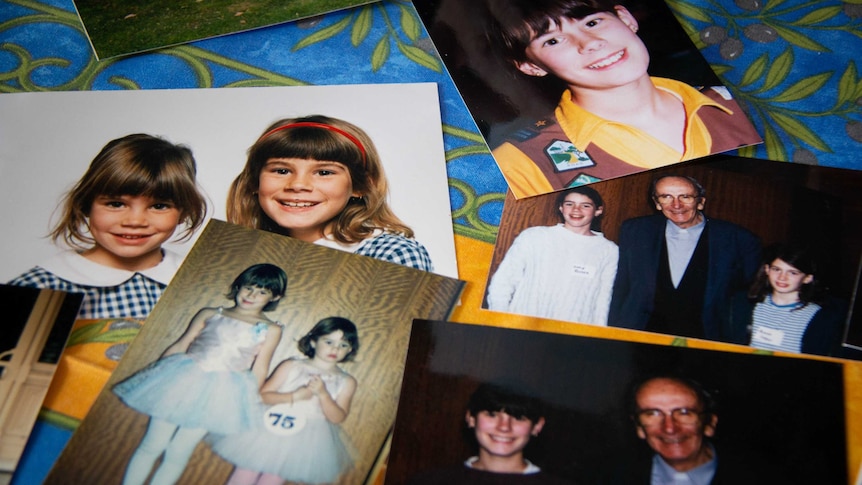 Photos of the Foster sisters as kids are spread out on a table.