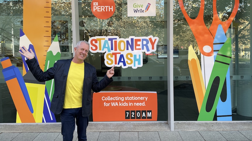 Mark Gibson stands in front of Stationery Stash window decalsat ABC Perth 