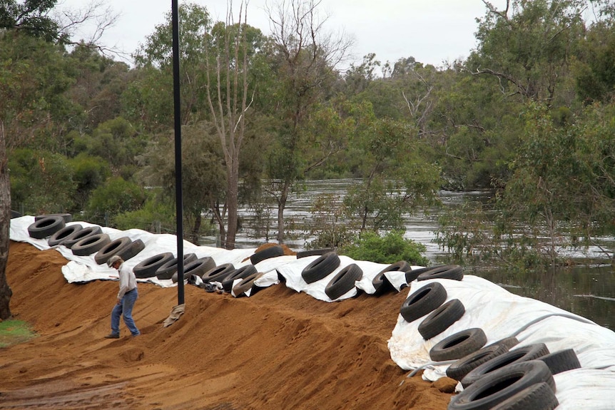 Tyres on a dirt mound surround the banks of the river at Boyup Brook.