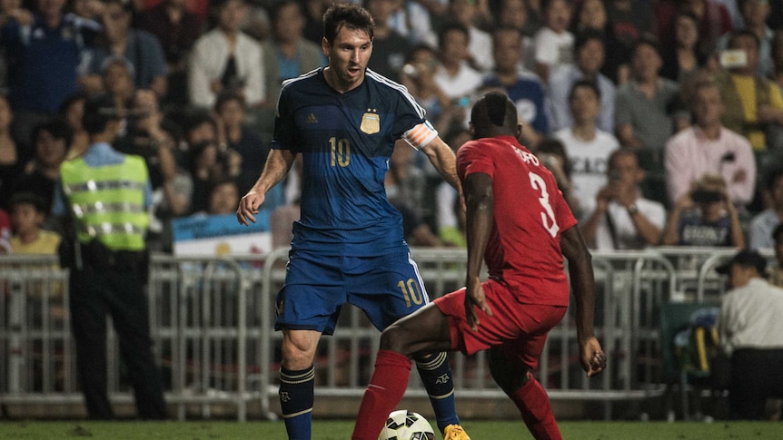 Messi dribbles against Hong Kong
