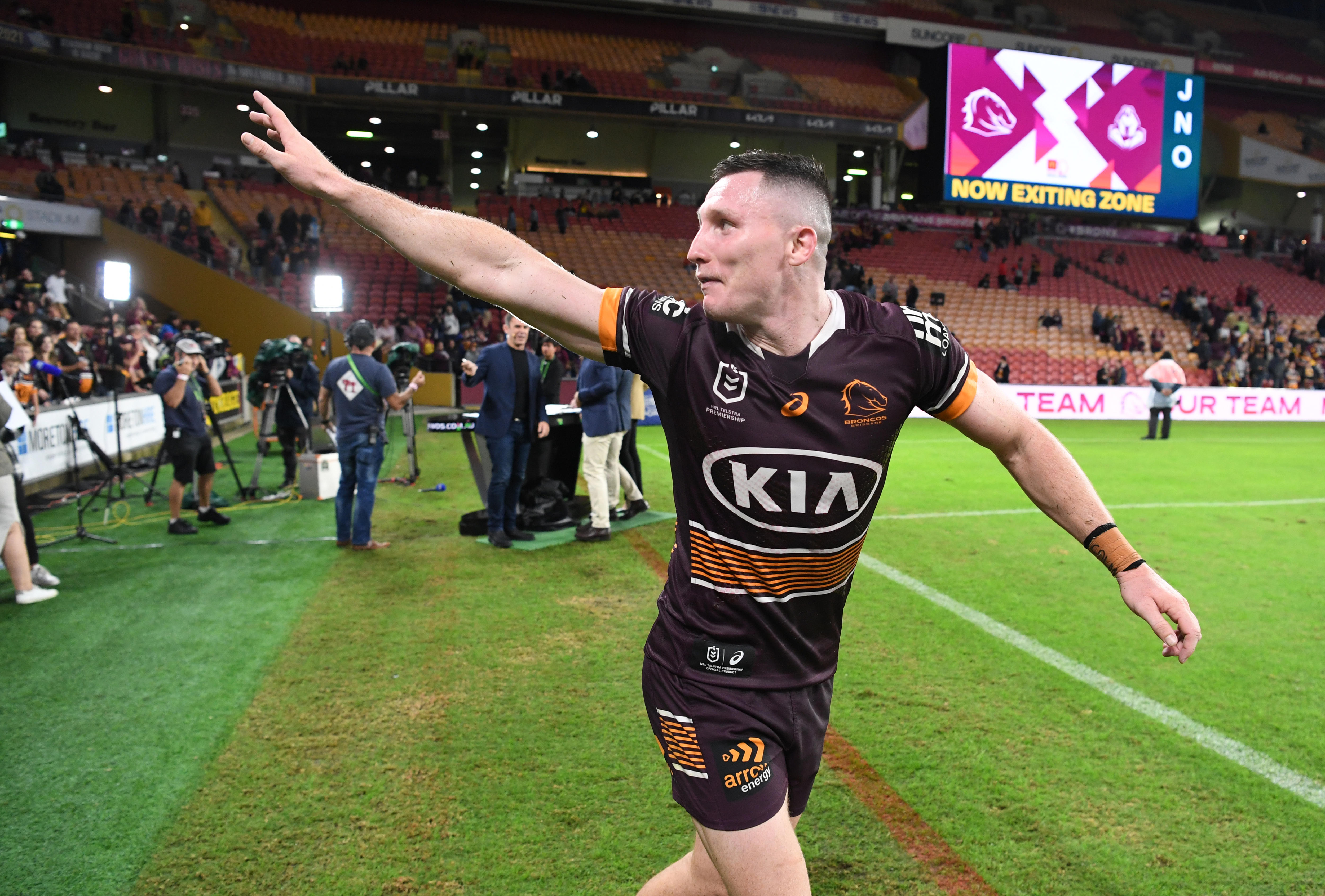 Brisbane Broncos player Tyson Gamble waves to fans on the sideline at Suncorp Stadium after an NRL game.