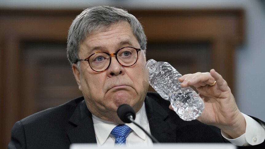 William Barr drinks from a bottle of water