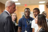 US Attorney-General Eric Holder shakes hands with student Bri Ehsan after a meeting in Ferguson, Missouri.