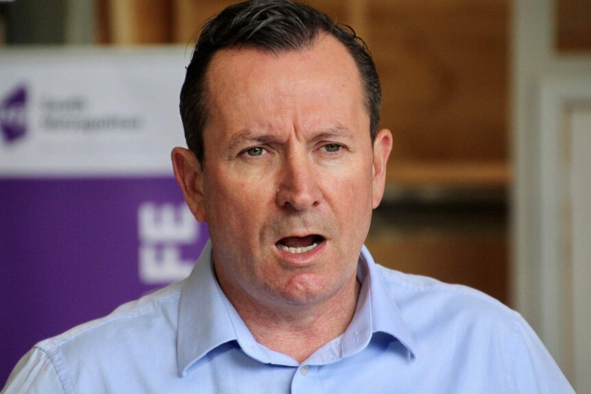 Mark McGowan speaking to reporters during a press conference in Mandurah in front of a TAFE banner