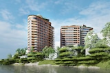 Two residential towers by a river.