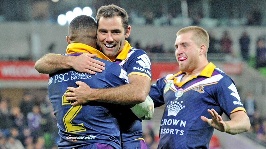 Paying tribute ... Cameron Smith (R), playing his 300th NRL match, congratulates Marika Koroibete on a try