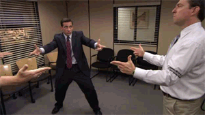 GIF of Steve Carrell and two colleagues in The Office putting 'finger weapons' down