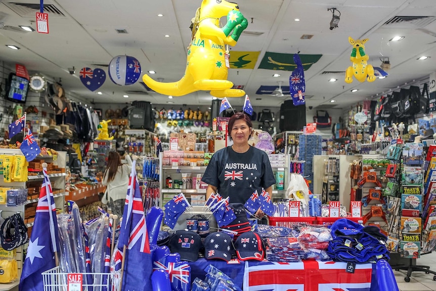 A woman in a shop full of Australian themed merchandise