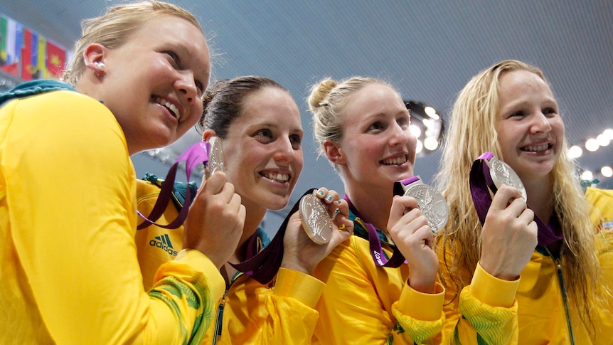 Members of Australia's 4x200m freestyle relay team hold their silver medals.