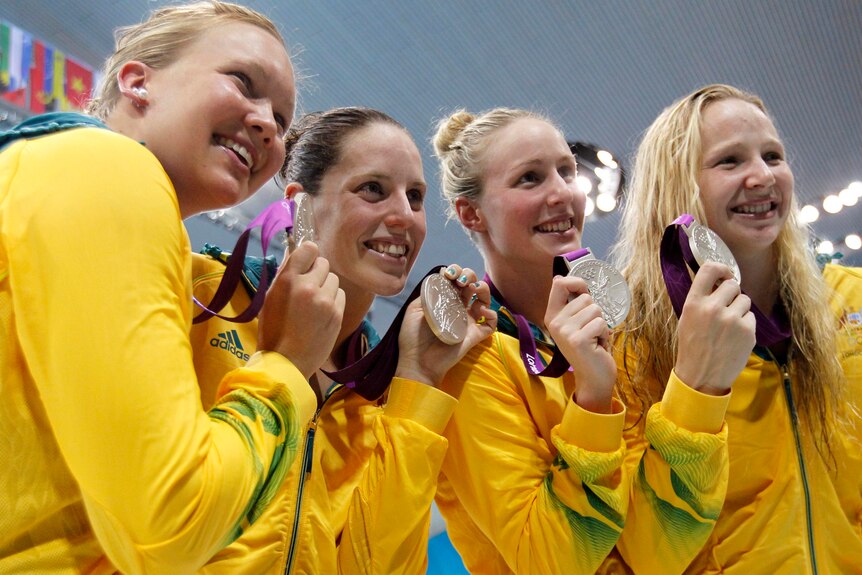 Members of Australia's 4x200m freestyle relay team hold their silver medals.