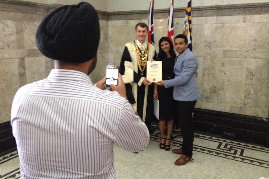 New Australian citizens pose for photos with Brisbane Lord Mayor.