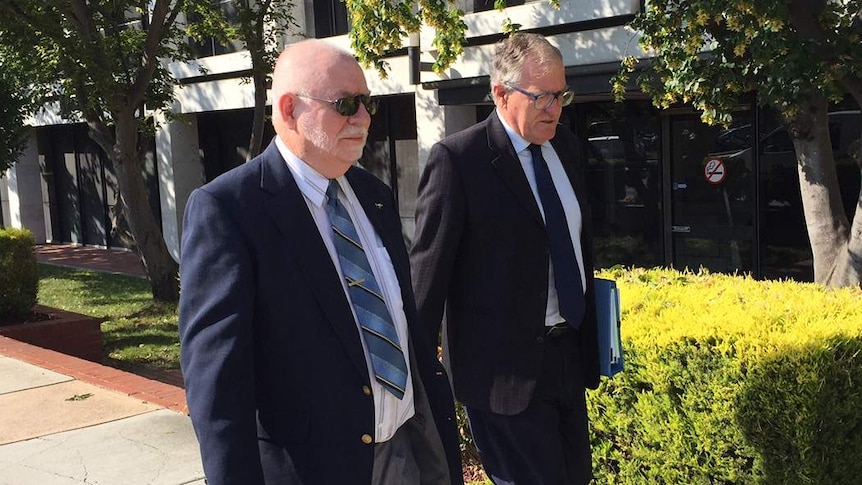 Gregory Joseph Sutton (left) outside the ACT Magistrates Court with his lawyer.