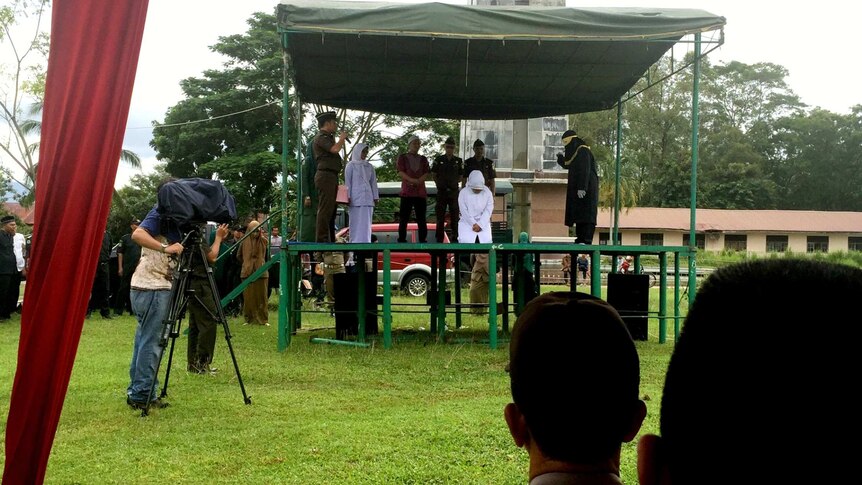 Kiranti on a platfrom being caned in Aceh
