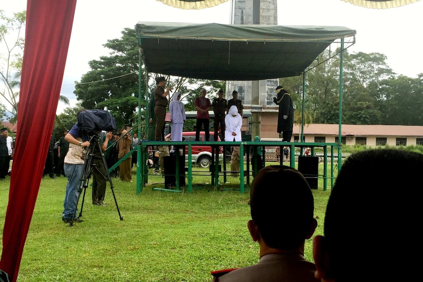 Kiranti on a platfrom being caned in Aceh