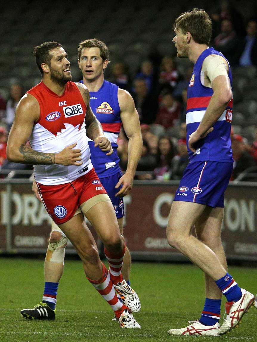 Sydney's Lance Franklin gets in the faces of the Western Bulldogs defenders after a goal to the Swans