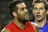 Sydney's Lance Franklin gets in the faces of the Western Bulldogs defenders at Docklands.
