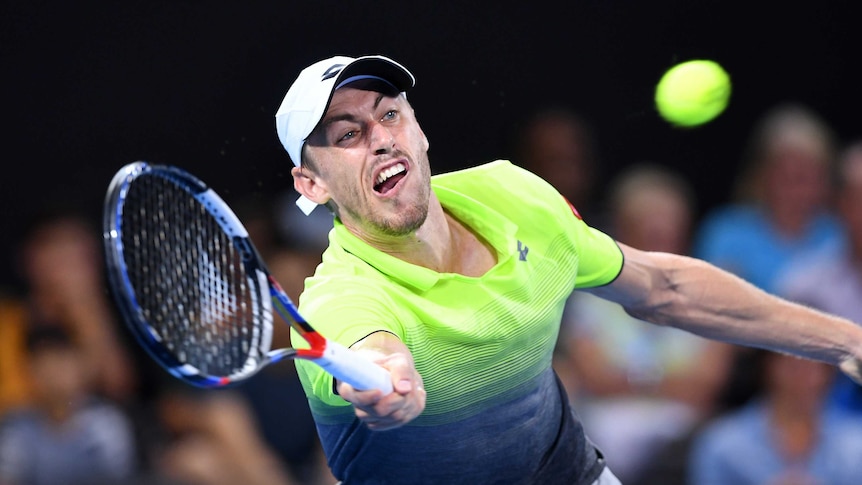 John Millman stretches for a forehand