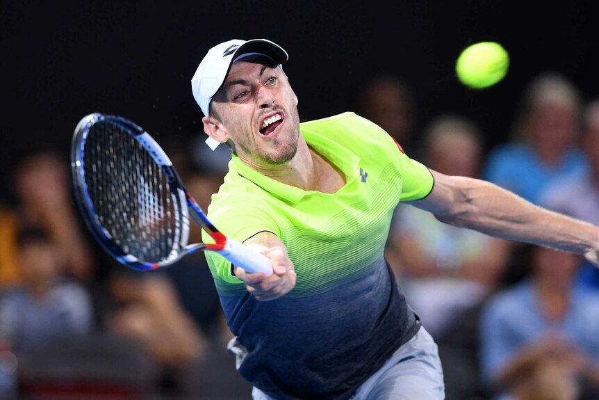 John Millman stretches for a forehand