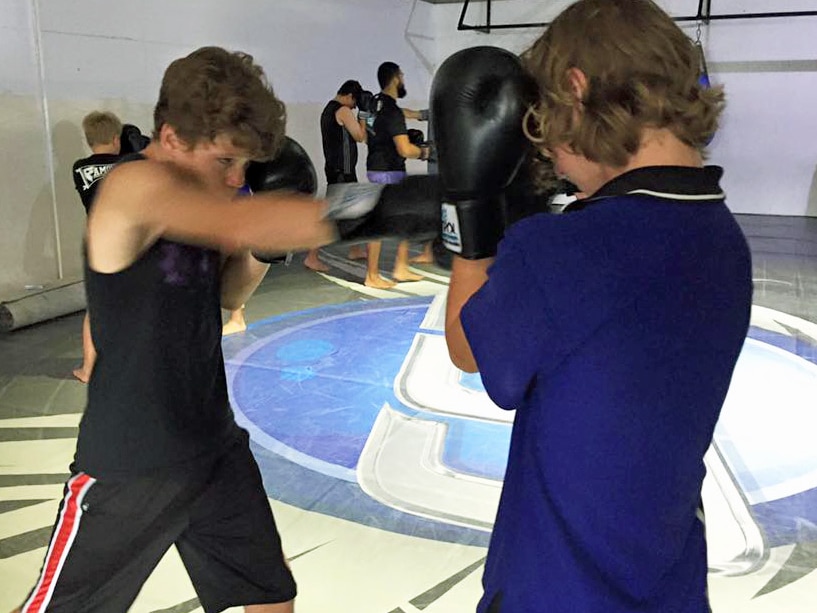 youths doing boxing, self-defence in a gym