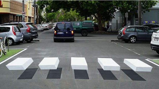 A road with the effect of a raised pedestrian crossing.