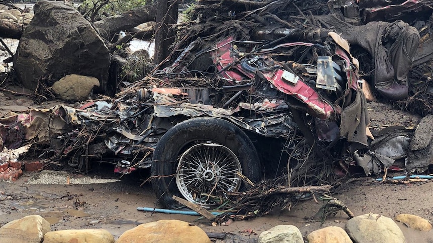 Parts of a damaged car are entangled in debris after mudslides in Montecito