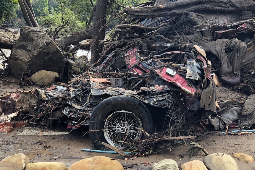 Parts of a damaged car are entangled in debris after mudslides in Montecito
