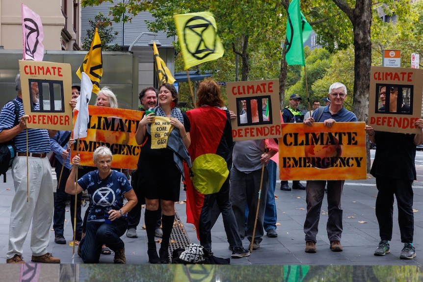 A group of protesters holding climate change signs
