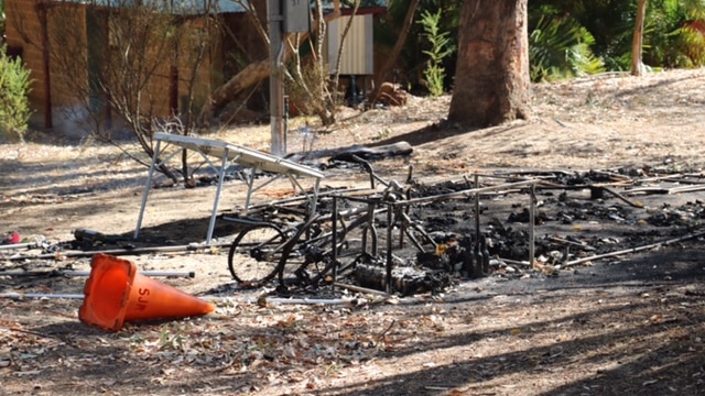 Burned out bicycle rack at Navarino Forest Resort camping ground.