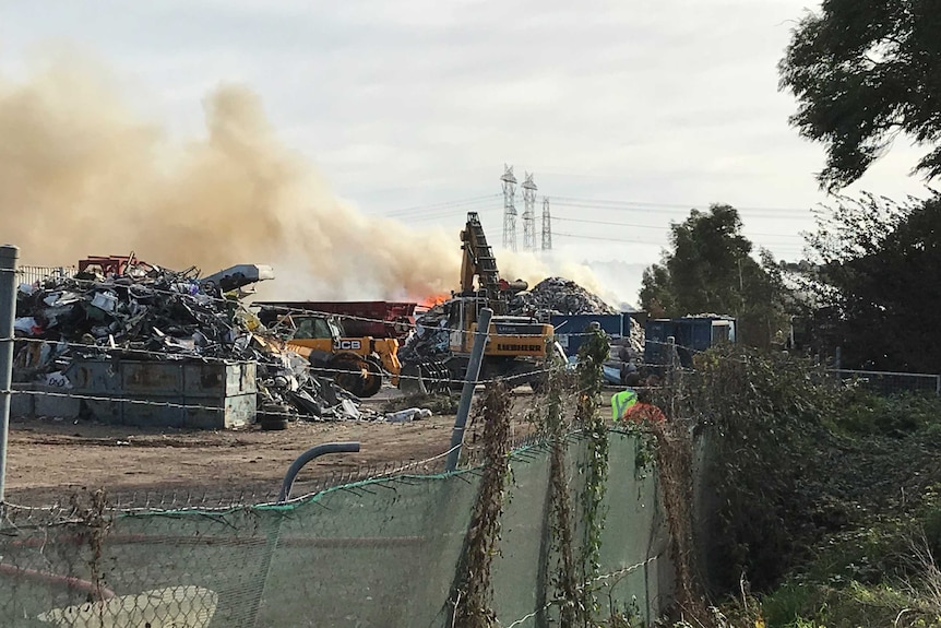 Smoke billows from a recycling centre fire.