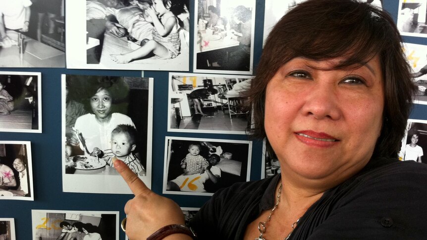 Former MG99 refugee, Mai Tuong Ly, points to a photo of her son, Chinh Duc Hong.