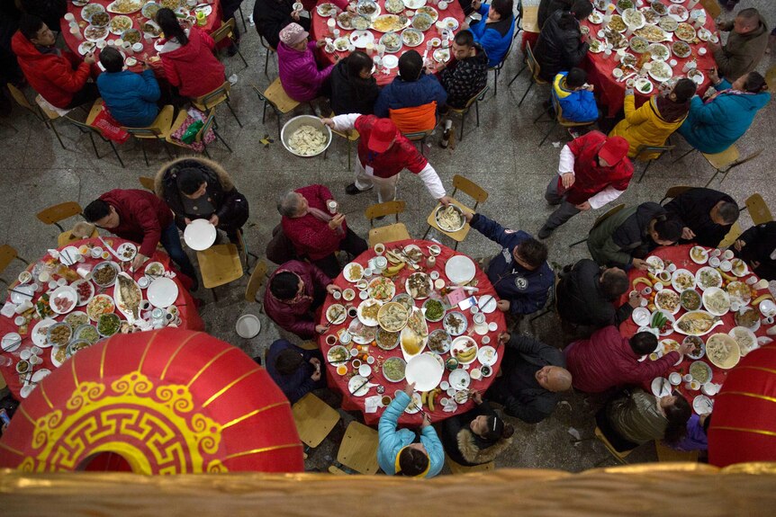 A waiter serves up dumplings on the eve of Chinese New Year during a large feast.