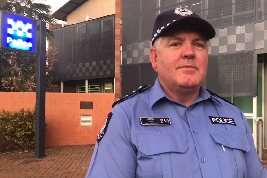 police officer standing in front of police station