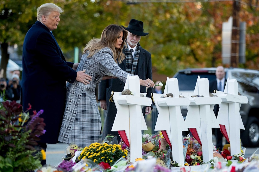 Melania Trump places a flower at a memorial for the victims of the Pittsburgh synagogue shooting.