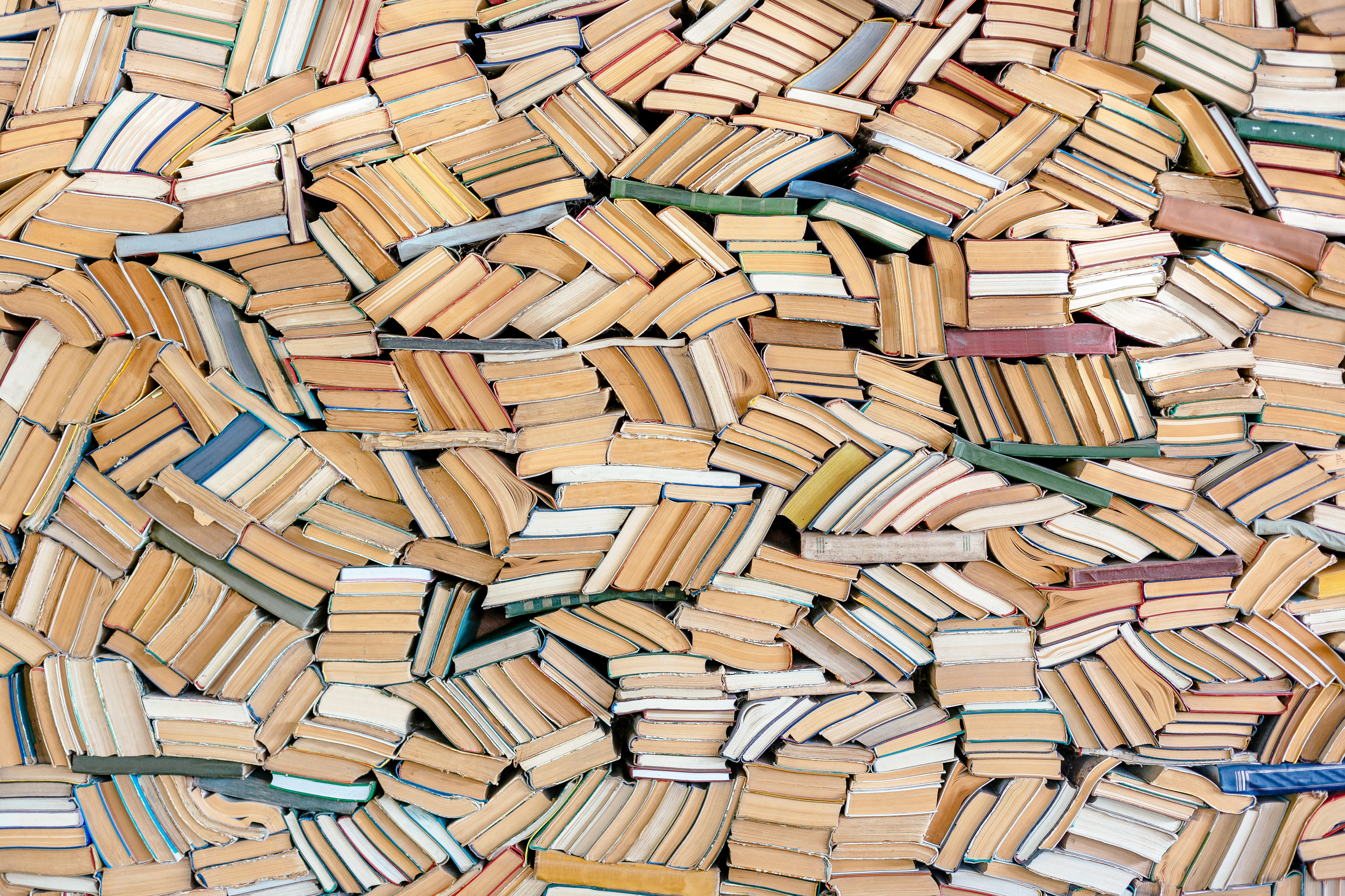 Image of many, many books all stacked together to fill the whole frame.