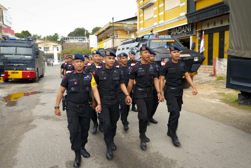 A platoon of police officers march in West Papua.