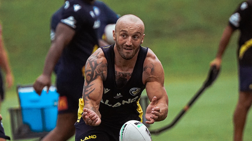 A man passes the ball at Parramatta Eels training