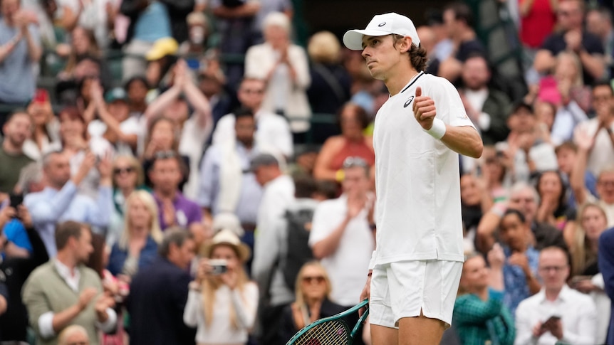 Tennis player Alex de Minaur gives the thumbs up in front of the Wimbledon crowd.